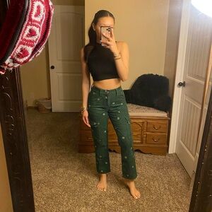 emerald green corduroy cargo pants with embroidered dice detailing